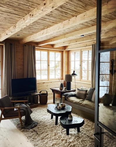 a living room with a couch and a tv at Stefan Glowacz CHALET mit traumhaftem Bergblick in Grainau