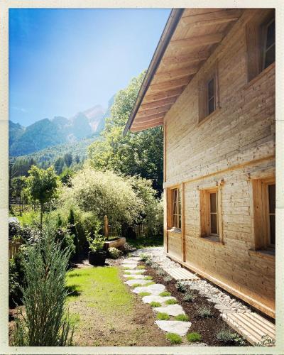 a house with a stone path next to a building at Stefan Glowacz CHALET mit traumhaftem Bergblick in Grainau