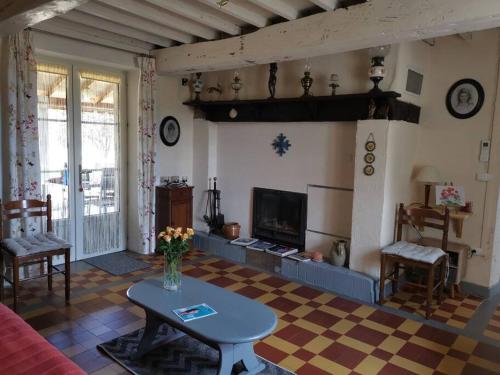 sala de estar con mesa y chimenea en Gîte familial de charme entier en Gascogne, en Marseillan