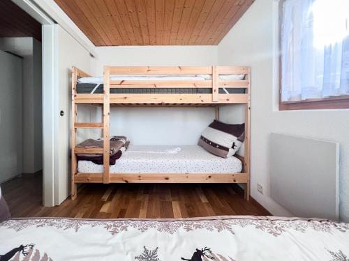 a bedroom with two bunk beds in a room at Chalet Dennda Nr 27 in Rosswald