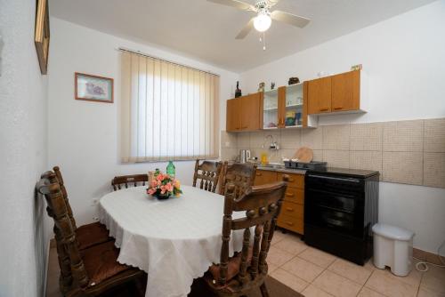 a kitchen with a table with a vase of flowers on it at Kuca za odmor Jozic in Golubić