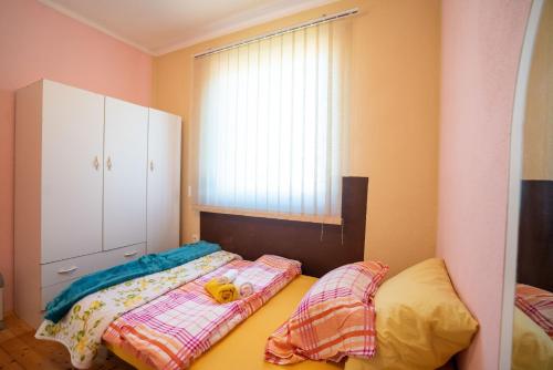 a bedroom with a bed with a stuffed animal on it at Kuca za odmor Jozic in Golubić