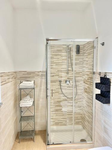 a shower with a glass door in a bathroom at Alloggio Nina 2 in Biella