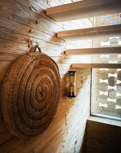 a wall in a cabin with a large coil of wood at Stefan Glowacz CHALET mit traumhaftem Bergblick in Grainau