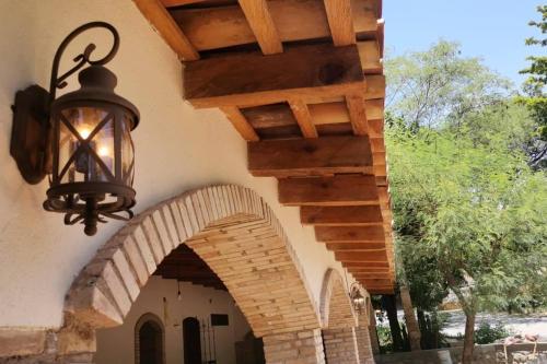 an arched entryway to a house with a light fixture at Casa Rustica Reserva Biosfera Tehuacan Cuicatlan 