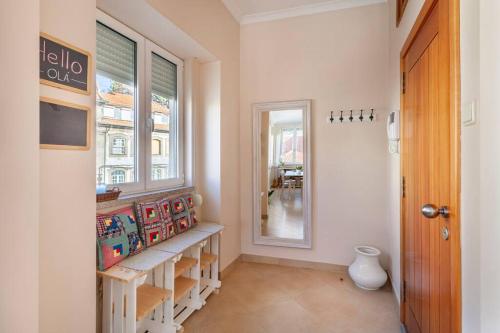 a hallway with a shelf and a window and a door at Charming 120m² in Historic Center in Lamego