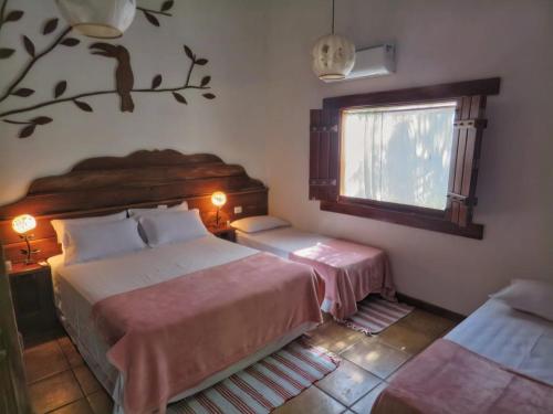 Aymara Lodge في بوكونيه: غرفة نوم بسريرين ونافذة