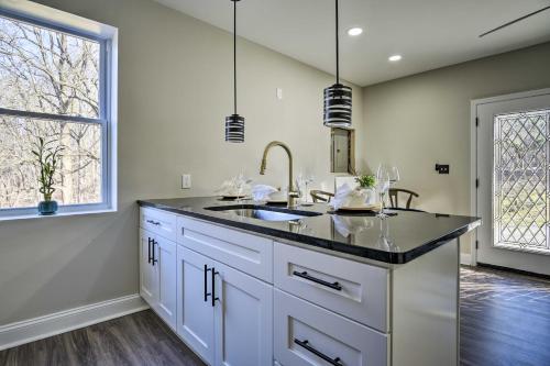 a kitchen with a sink and two windows at Newark Rental Near University of Delaware! in Newark