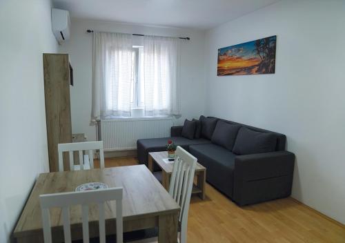 a living room with a couch and a table at Aster Apartments in Belgrade