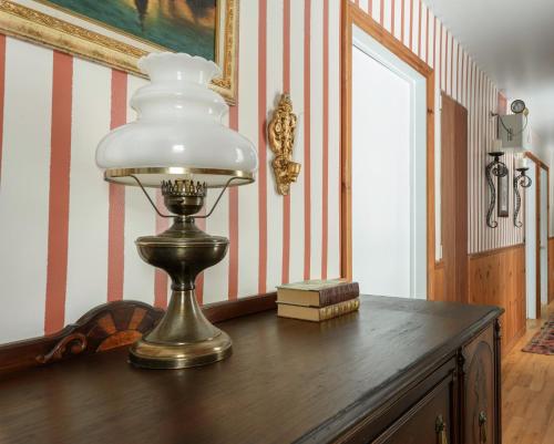 a lamp sitting on top of a wooden table at Maison Sherman's house in Scotstown
