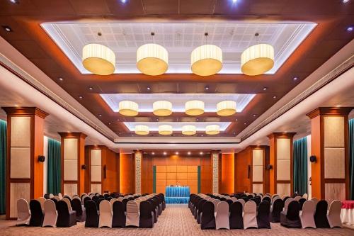 a large banquet hall with chairs and a large ceiling at Residency Tower in Trivandrum
