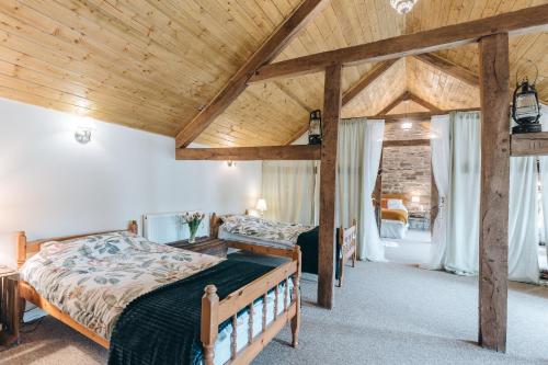 a bedroom with a bed and a wooden ceiling at The Grain Loft in Clun