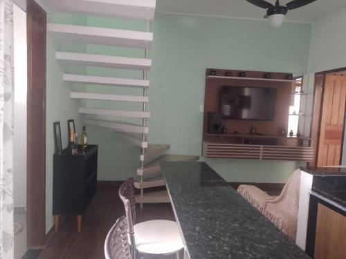 a living room with a staircase and a tv at Casa Griebeler 01 in Rio de Janeiro