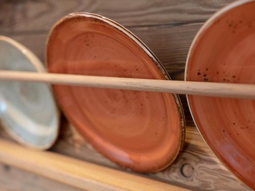 a group of wooden spoons on a shelf at Brunnwirt ESSEN & WOHNEN in Fuschl am See