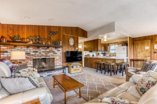 a living room with two couches and a fireplace at Ocean Vista Vacation Home in Seaside