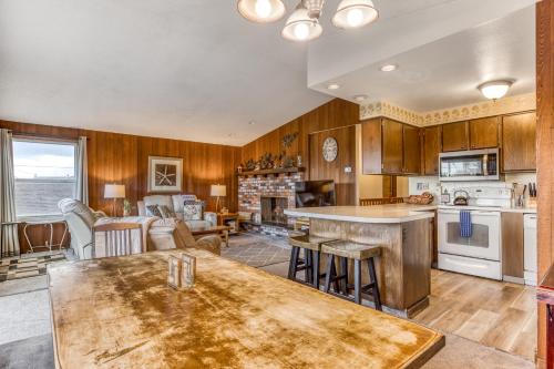 a large kitchen with wooden cabinets and a table at Ocean Vista Vacation Home in Seaside