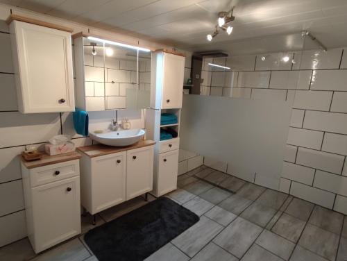ein Badezimmer mit Waschbecken und Spiegel in der Unterkunft Geräumige Wohnung im Schwarzwald in Seelbach