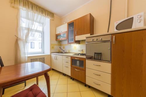 a kitchen with a wooden table and a table sidx sidx sidx at DayFlat Apartments Maidan Area in Kyiv