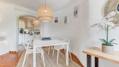 a white dining room with a white table and chairs at Bella Amore Campanet in Campanet