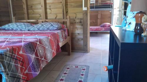 sypialnia z łóżkiem i biurkiem w pokoju w obiekcie Petit chalet vacance w mieście Vidon