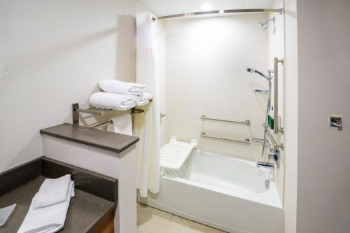 a white bathroom with a shower and a bath tub at Fairfield Inn & Suites Scranton Montage Mountain in Moosic