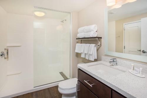 a bathroom with a sink and a toilet and a mirror at TownePlace Suites by Marriott Cookeville in Cookeville