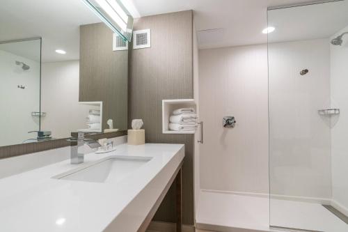 a bathroom with a sink and a shower at Courtyard by Marriott West Springfield in West Springfield