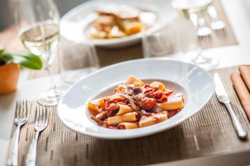 a white plate of food sitting on a table at Hotel degli Arcimboldi in Milan