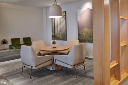 a room with a table and two chairs and a table at Fairfield Inn & Suites by Marriott Chicago O'Hare in Des Plaines