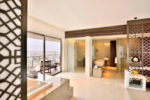 a bathroom with a tub and a view of the city at The Westin Hyderabad Mindspace in Hyderabad