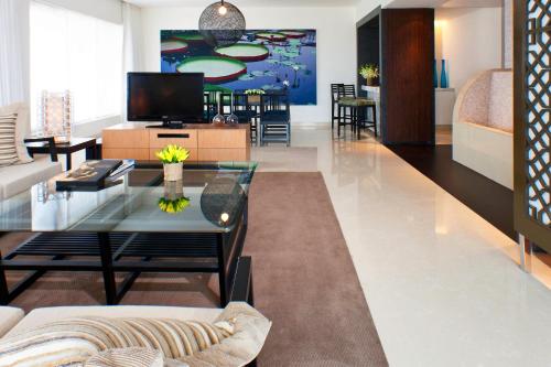 a living room with a couch and a table at The Westin Hyderabad Mindspace in Hyderabad