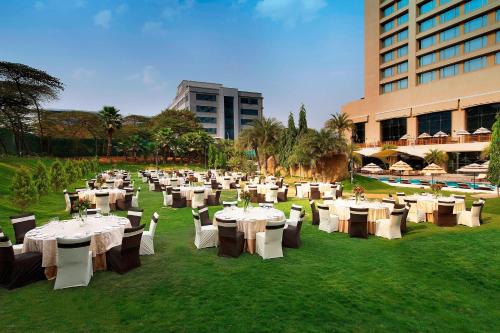 a group of tables and chairs in front of a building at The Westin Hyderabad Mindspace in Hyderabad