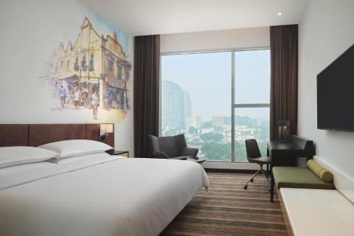 a hotel room with a bed and a large window at Four Points by Sheraton Kuala Lumpur, Chinatown in Kuala Lumpur