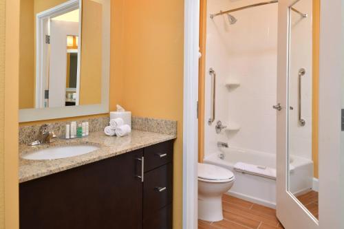 a bathroom with a sink and a toilet and a shower at TownePlace Suites by Marriott Detroit Commerce in Walled Lake
