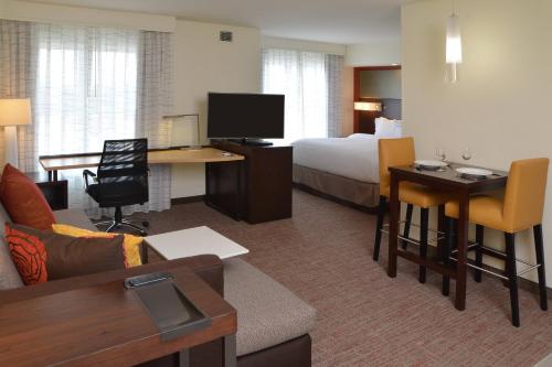a hotel room with a bed and a desk with a computer at Residence Inn by Marriott Akron Fairlawn in Fairlawn