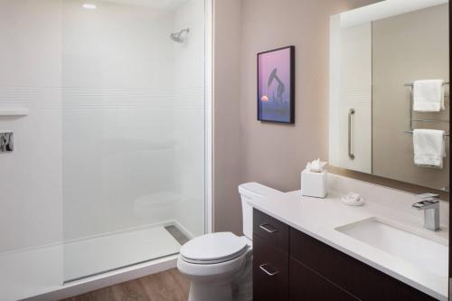 a bathroom with a shower and a toilet and a sink at TownePlace Suites Midland South/I-20 in Midland