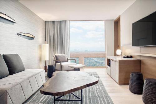 a living room with a couch and a tv at JW Marriott Hotel Mexico City Polanco in Mexico City