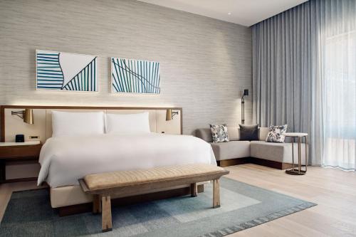 a bedroom with a large white bed and a couch at JW Marriott Hotel Mexico City Polanco in Mexico City