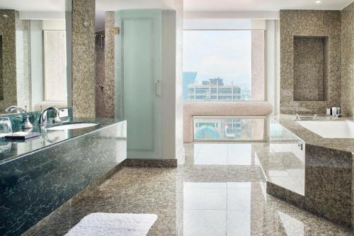 a bathroom with two sinks and a large window at JW Marriott Hotel Mexico City Polanco in Mexico City