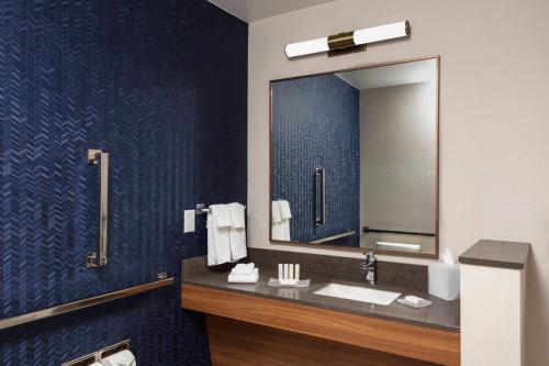 a bathroom with a sink and a mirror at Fairfield by Marriott Inn & Suites Medford in Medford