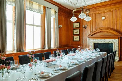 a large long table in a room with chairs and tables at London Marriott Hotel County Hall in London