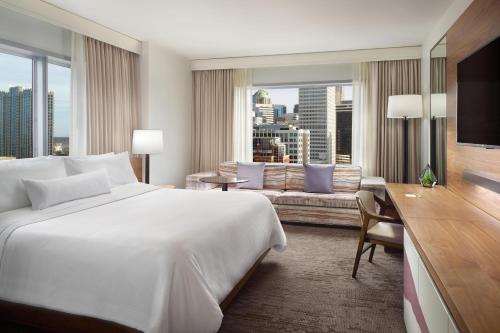 a hotel room with a large bed and a couch at The Westin Charlotte in Charlotte