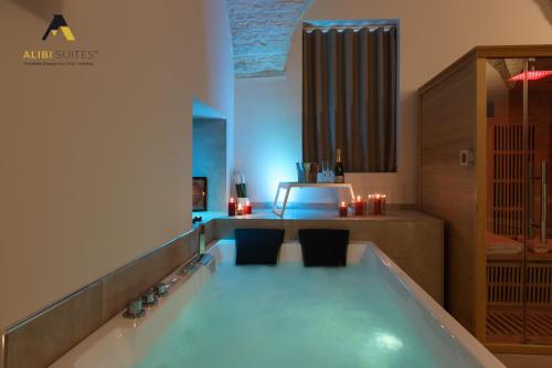 uma casa de banho com banheira e 2 cadeiras em [Alibi Suites] Suite Fieramosca Spa & Relax em Ruvo di Puglia