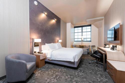 Pokój hotelowy z łóżkiem i biurkiem w obiekcie Courtyard by Marriott Waterloo Cedar Falls w mieście Waterloo