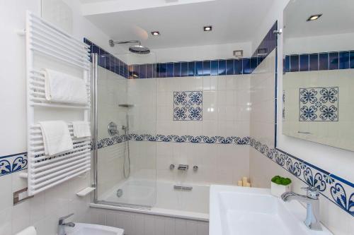 a bathroom with a shower and a sink and a tub at DieciSedici in Amalfi
