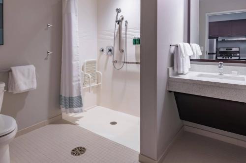 a bathroom with a shower and a toilet and a sink at TownePlace Suites by Marriott Leavenworth in Leavenworth