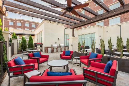 a patio with chairs and tables and a ceiling fan at Residence Inn Franklin Berry Farms in Franklin
