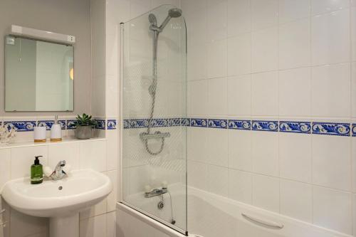 a bathroom with a shower and a sink and a toilet at Waters Edge - stylish marina retreat in Pevensey