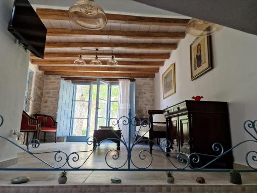 a living room with a piano and a table at PYRGOS - Traditional house at Kaloxilos, Naxos in Khalkíon