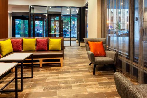 a lobby with a couch and two chairs and tables at Fairfield Inn and Suites Chicago Downtown-River North in Chicago